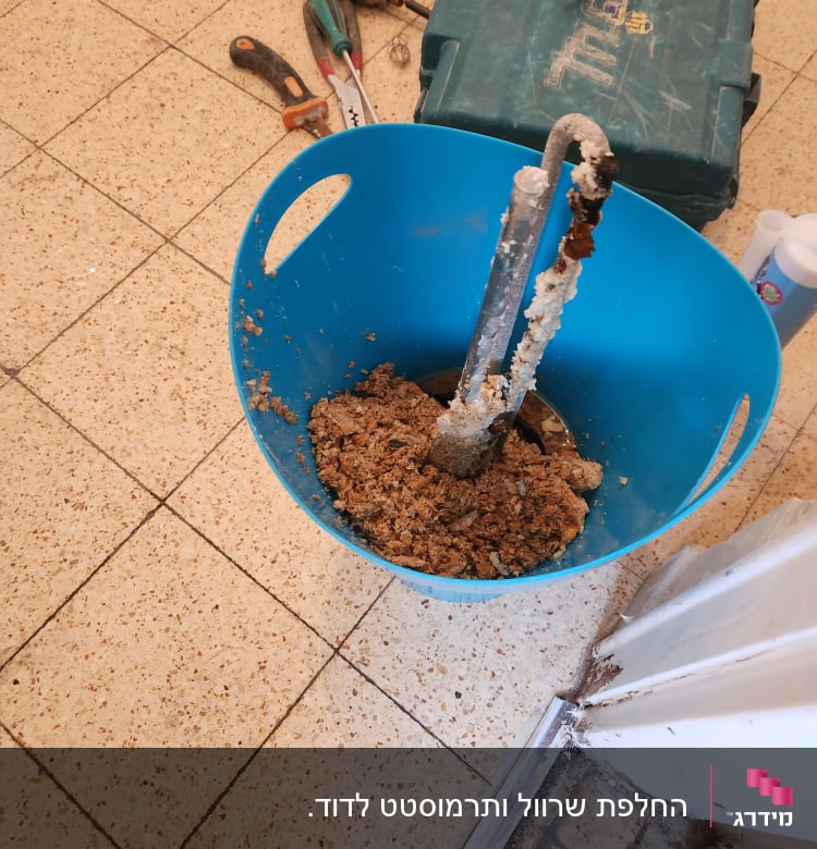 כלי עבודה חשמליים ודלי עם חומר בנייה